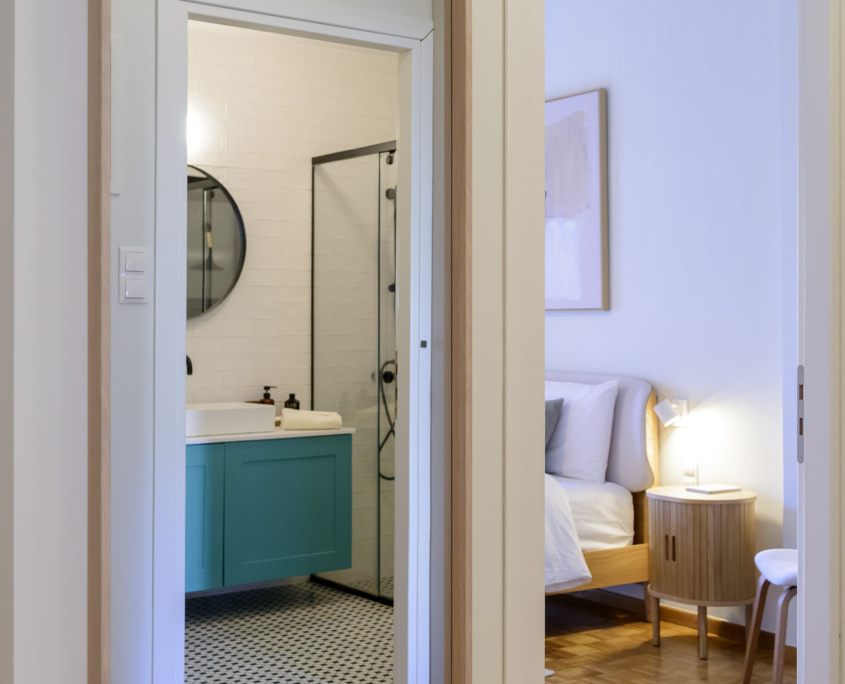 Large mirror in hallway connecting bedroom and bathroom in furnished long stay apartment in Ano Petralona, Athens